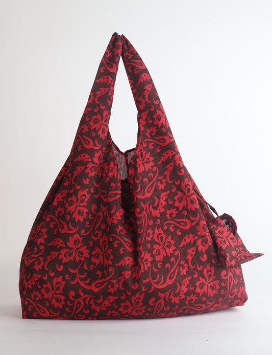 Stay eco-conscious with our Reusable Bag, handmade by Indian artisans from pre-loved saris. Silky and lightweight, this foldaway bag is perfect for your on-the-go lifestyle. Each piece is a unique statement of ethical fashion, embracing sustainability and style.