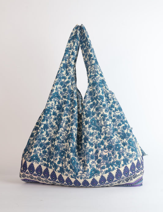 Stay eco-conscious with our Reusable Bag, handmade by Indian artisans from pre-loved saris. Silky and lightweight, this foldaway bag is perfect for your on-the-go lifestyle. Each piece is a unique statement of ethical fashion, embracing sustainability and style.