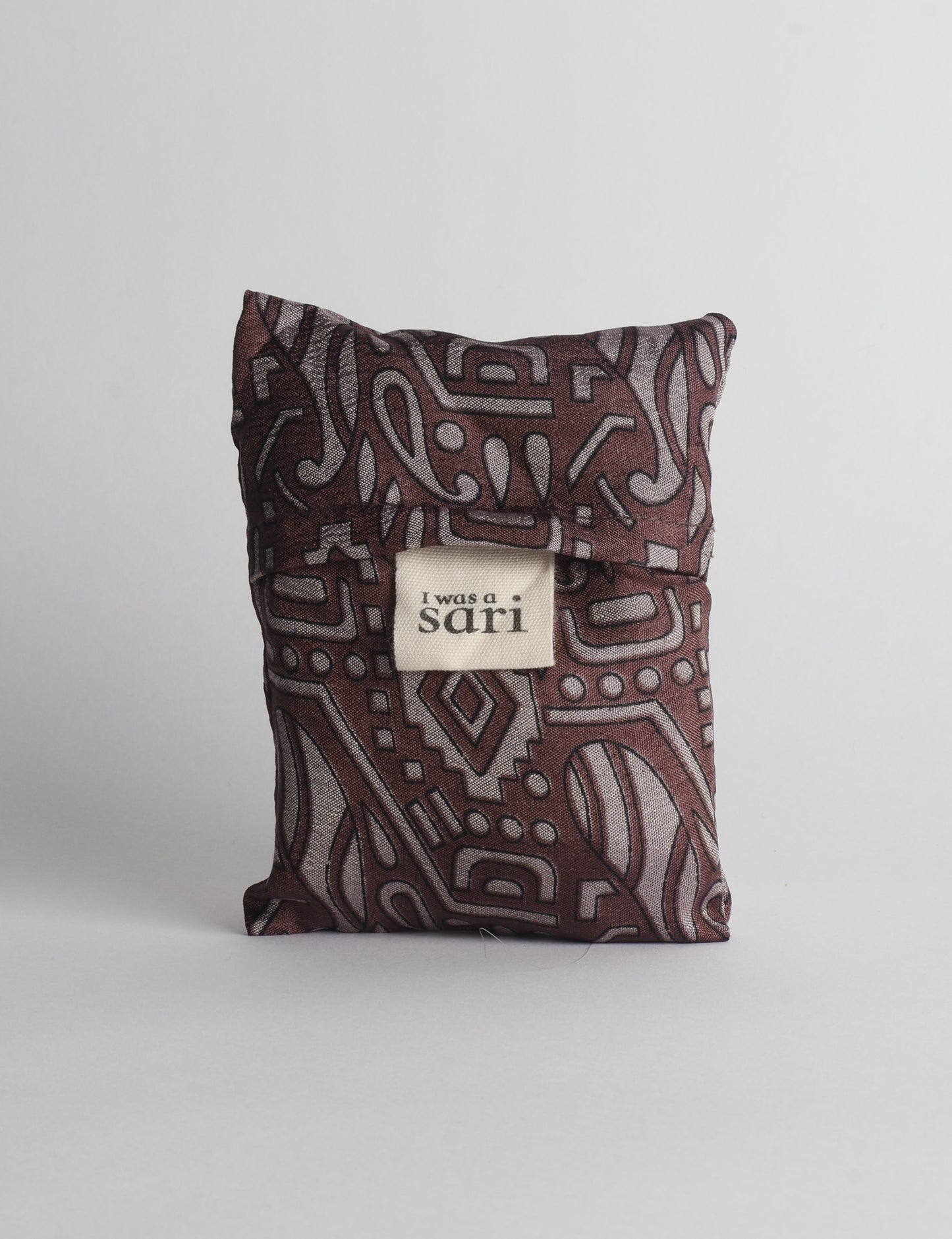 Stay eco-conscious with our Reusable Bag, handmade by Indian artisans from pre-loved saris. Silky and lightweight, this foldaway bag is perfect for your on-the-go lifestyle. Each piece is a unique statement of ethical fashion, embracing sustainability and style.