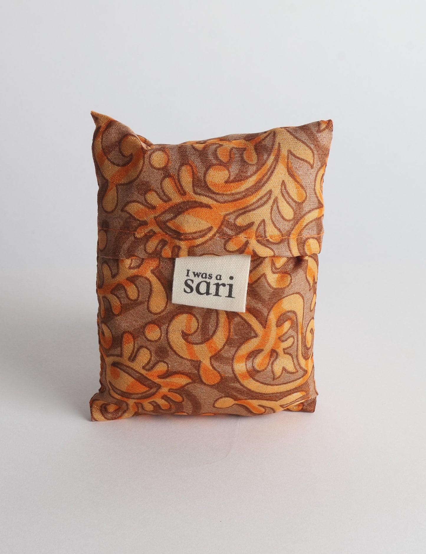 Stay eco-conscious with our Reusable Bag, handmade by Indian artisans from pre-loved saris. Silky and lightweight, this foldaway bag is perfect for your on-the-go lifestyle. Each piece is a unique statement of ethical fashion, embracing sustainability and style.