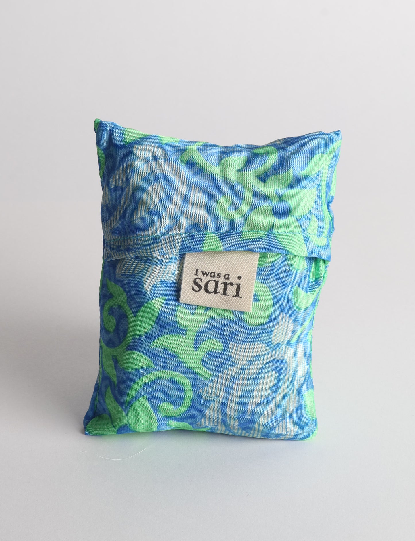 Stay eco-conscious with our Reusable Bag, handmade by Indian artisans from pre-loved saris. Silky and lightweight, this foldaway bag is perfect for your on-the-go lifestyle. Each piece is a unique statement of ethical fashion, embracing sustainability and style.