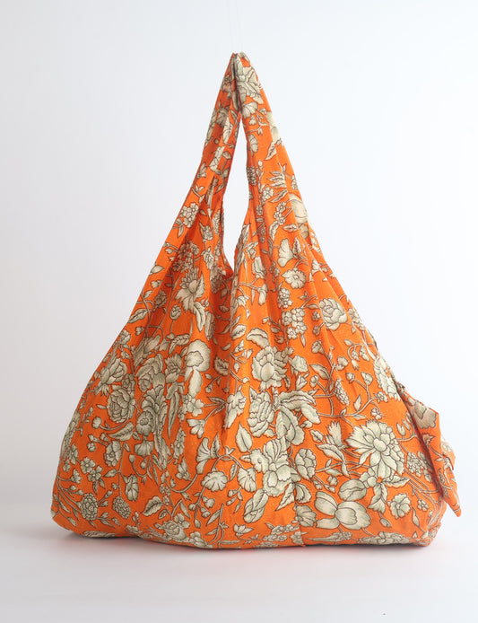 Stay eco-conscious with our Reusable Bag, handmade by Indian artisans from pre-loved saris. Silky and lightweight, this foldaway bag is perfect for your on-the-go lifestyle. Each piece is a unique statement of ethical fashion, embracing sustainability and style.