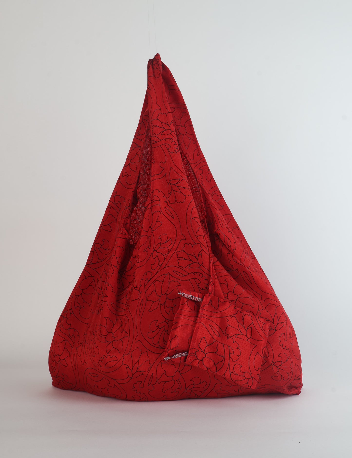 Stay eco-conscious with our Reusable Bag, handmade by Indian artisans from pre-loved saris. Silky and lightweight, this foldaway bag is perfect for your on-the-go lifestyle. Each piece is a unique statement of ethical fashion, embracing sustainability and style.