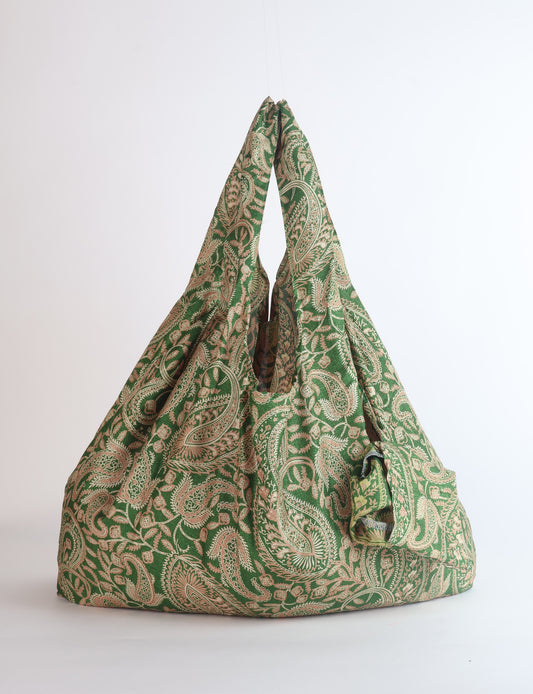 Stay eco-conscious with our Reusable Bag, handmade by Indian artisans from pre-loved saris. Silky and lightweight, this foldaway bag is perfect for your on-the-go lifestyle. Each piece is a unique statement of ethical fashion, embracing sustainability and style.