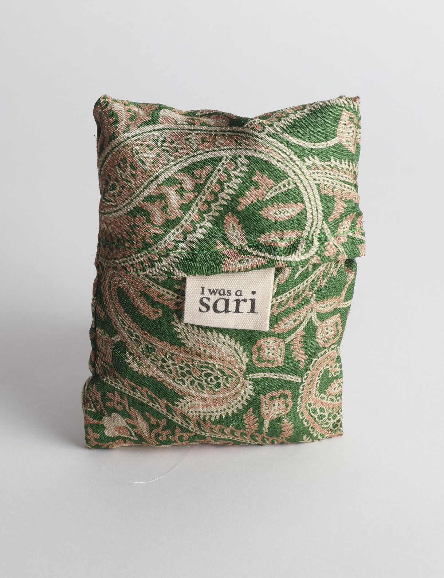 Stay eco-conscious with our Reusable Bag, handmade by Indian artisans from pre-loved saris. Silky and lightweight, this foldaway bag is perfect for your on-the-go lifestyle. Each piece is a unique statement of ethical fashion, embracing sustainability and style.