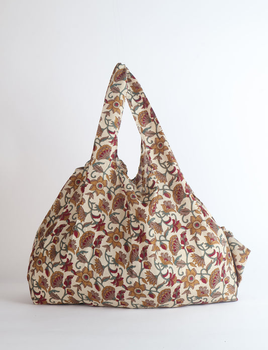Stay eco-conscious with our Reusable Bag, handmade by Indian artisans from pre-loved saris. Silky and lightweight, this foldaway bag is perfect for your on-the-go lifestyle. Each piece is a unique statement of ethical fashion, embracing sustainability and style.