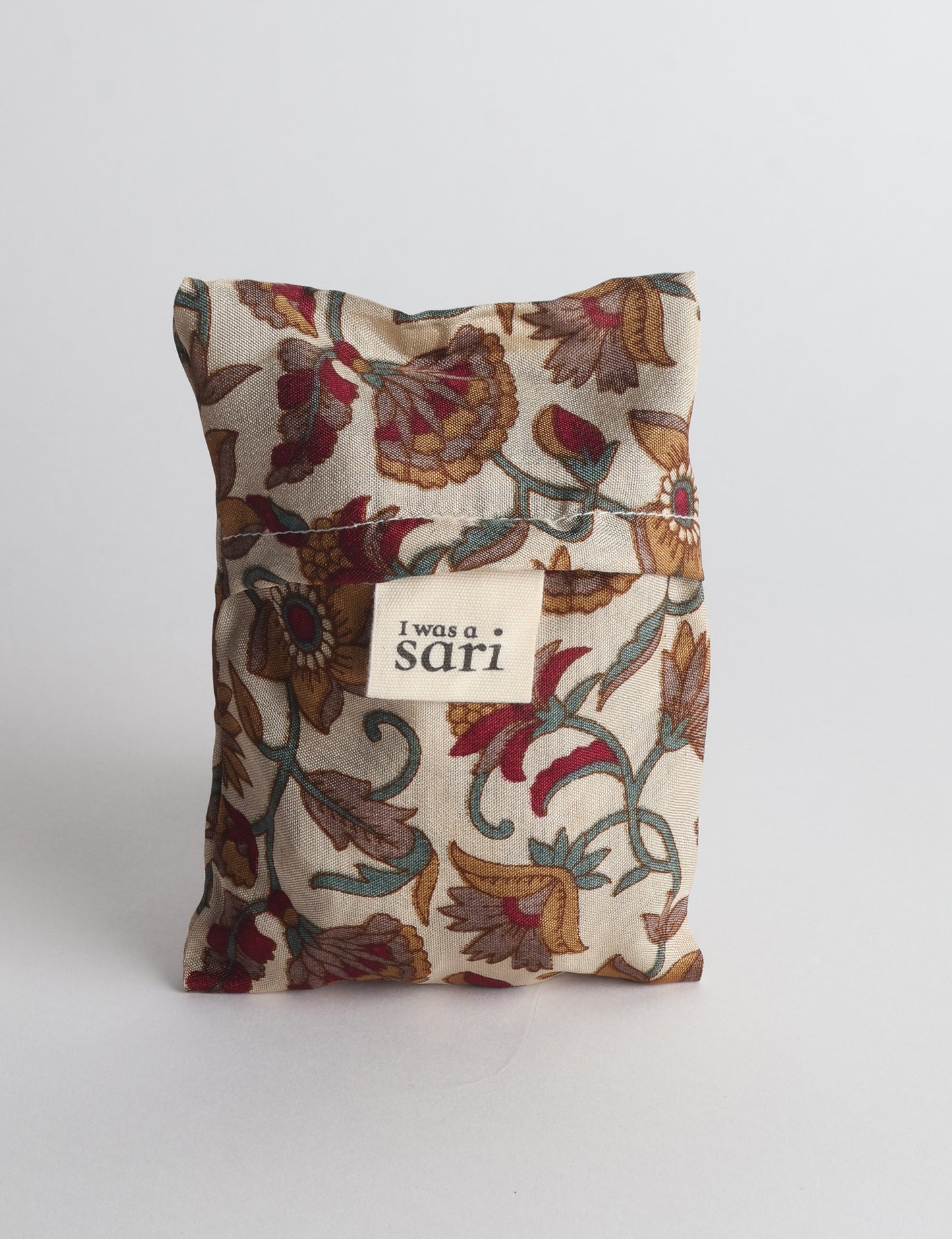 Stay eco-conscious with our Reusable Bag, handmade by Indian artisans from pre-loved saris. Silky and lightweight, this foldaway bag is perfect for your on-the-go lifestyle. Each piece is a unique statement of ethical fashion, embracing sustainability and style.