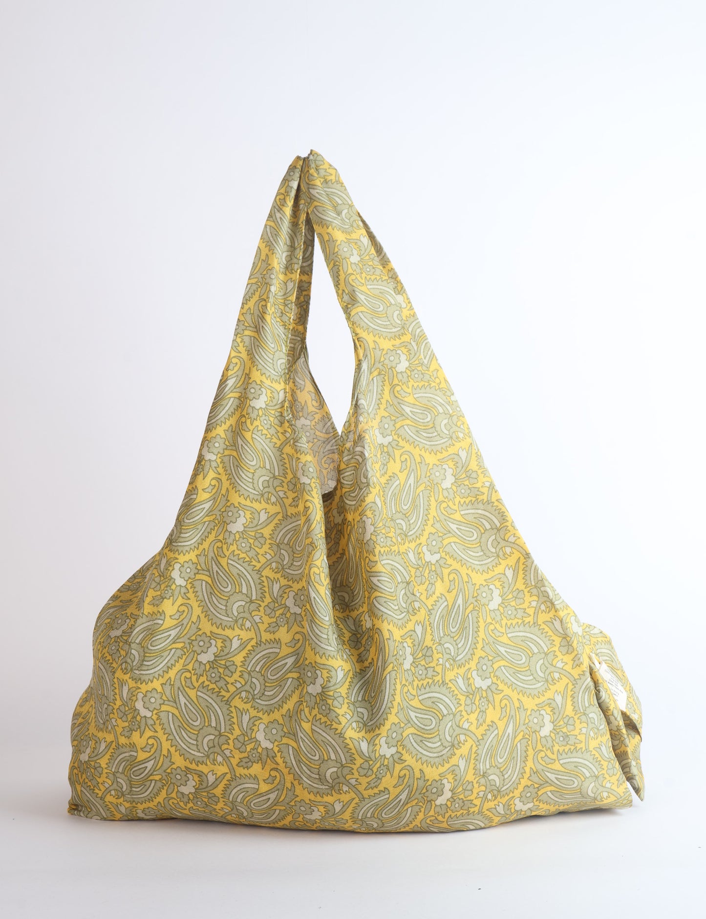 Stay eco-conscious with our Reusable Bag, handmade by Indian artisans from pre-loved saris. Silky and lightweight, this foldaway bag is perfect for your on-the-go lifestyle. Each piece is a unique statement of ethical fashion, embracing sustainability and style.