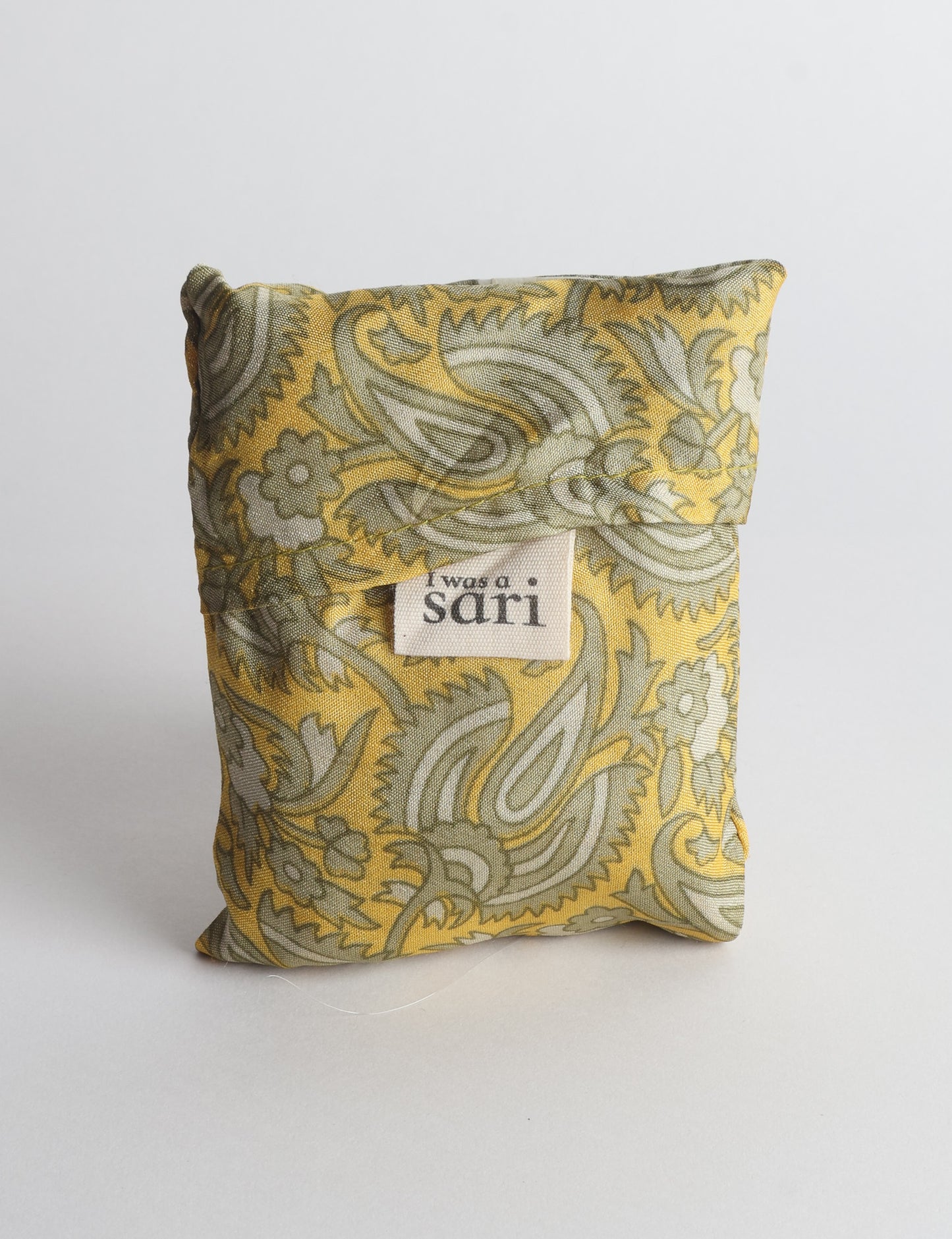 Stay eco-conscious with our Reusable Bag, handmade by Indian artisans from pre-loved saris. Silky and lightweight, this foldaway bag is perfect for your on-the-go lifestyle. Each piece is a unique statement of ethical fashion, embracing sustainability and style.