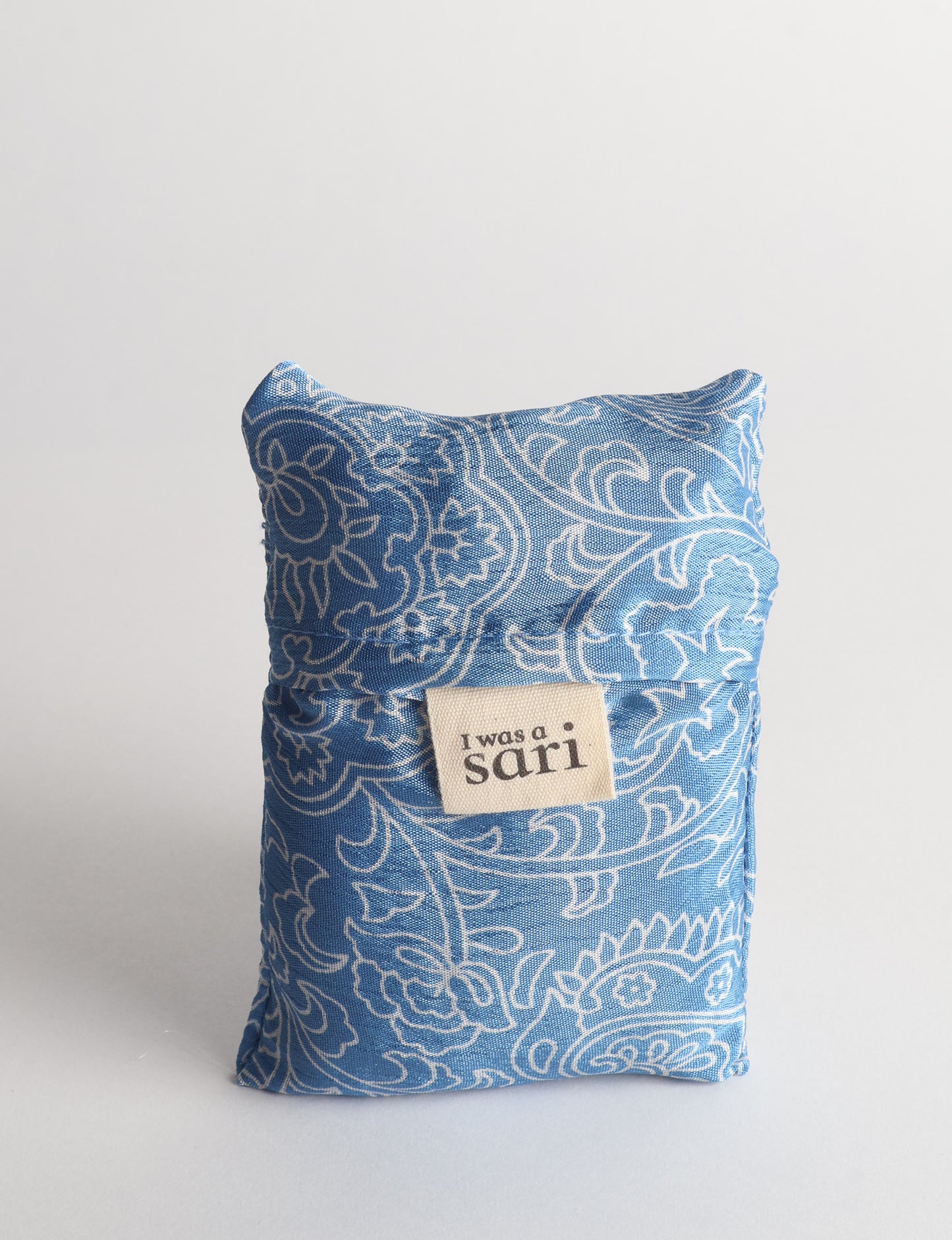 Stay eco-conscious with our Reusable Bag, handmade by Indian artisans from pre-loved saris. Silky and lightweight, this foldaway bag is perfect for your on-the-go lifestyle. Each piece is a unique statement of ethical fashion, embracing sustainability and style.