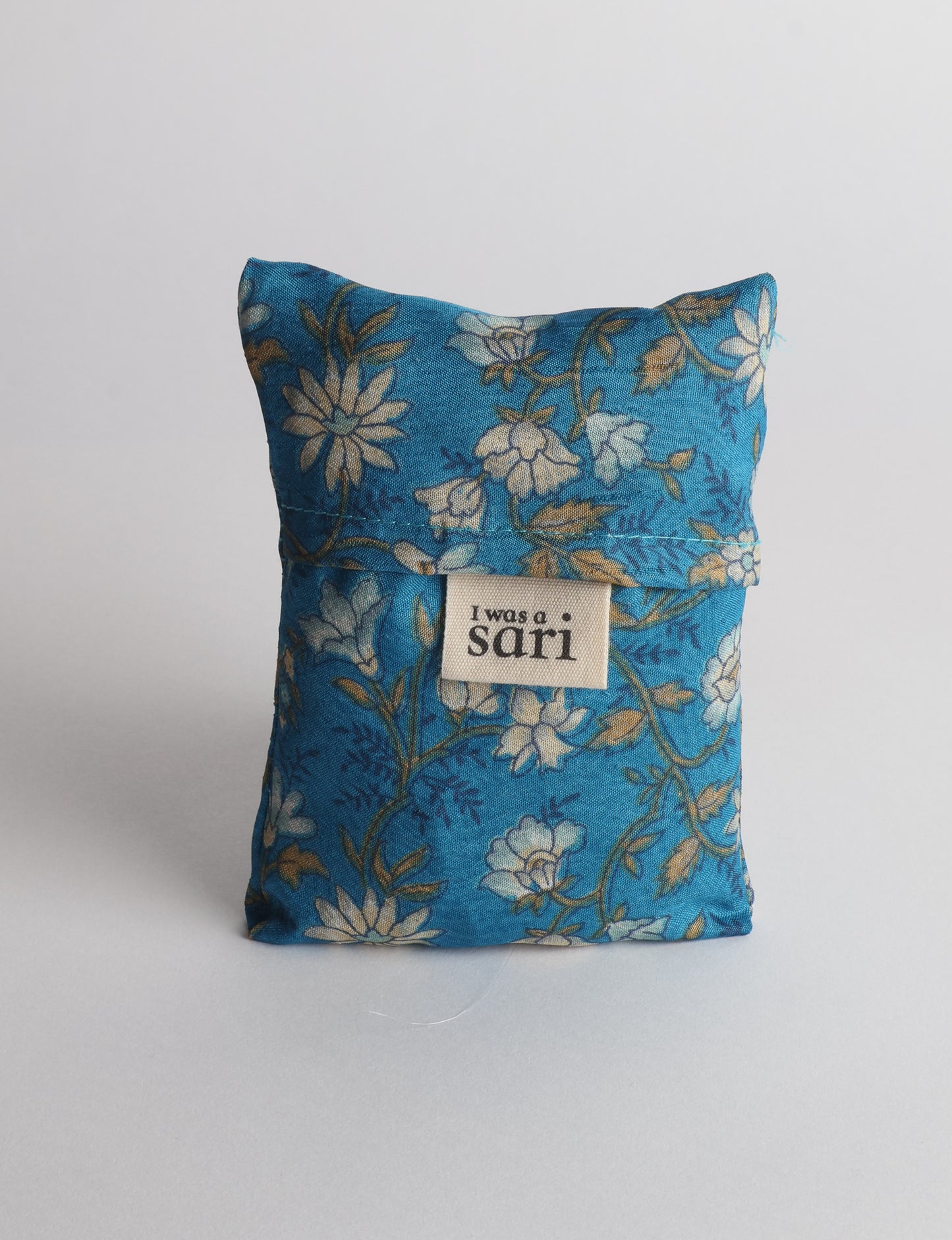 Stay eco-conscious with our Reusable Bag, handmade by Indian artisans from pre-loved saris. Silky and lightweight, this foldaway bag is perfect for your on-the-go lifestyle. Each piece is a unique statement of ethical fashion, embracing sustainability and style.