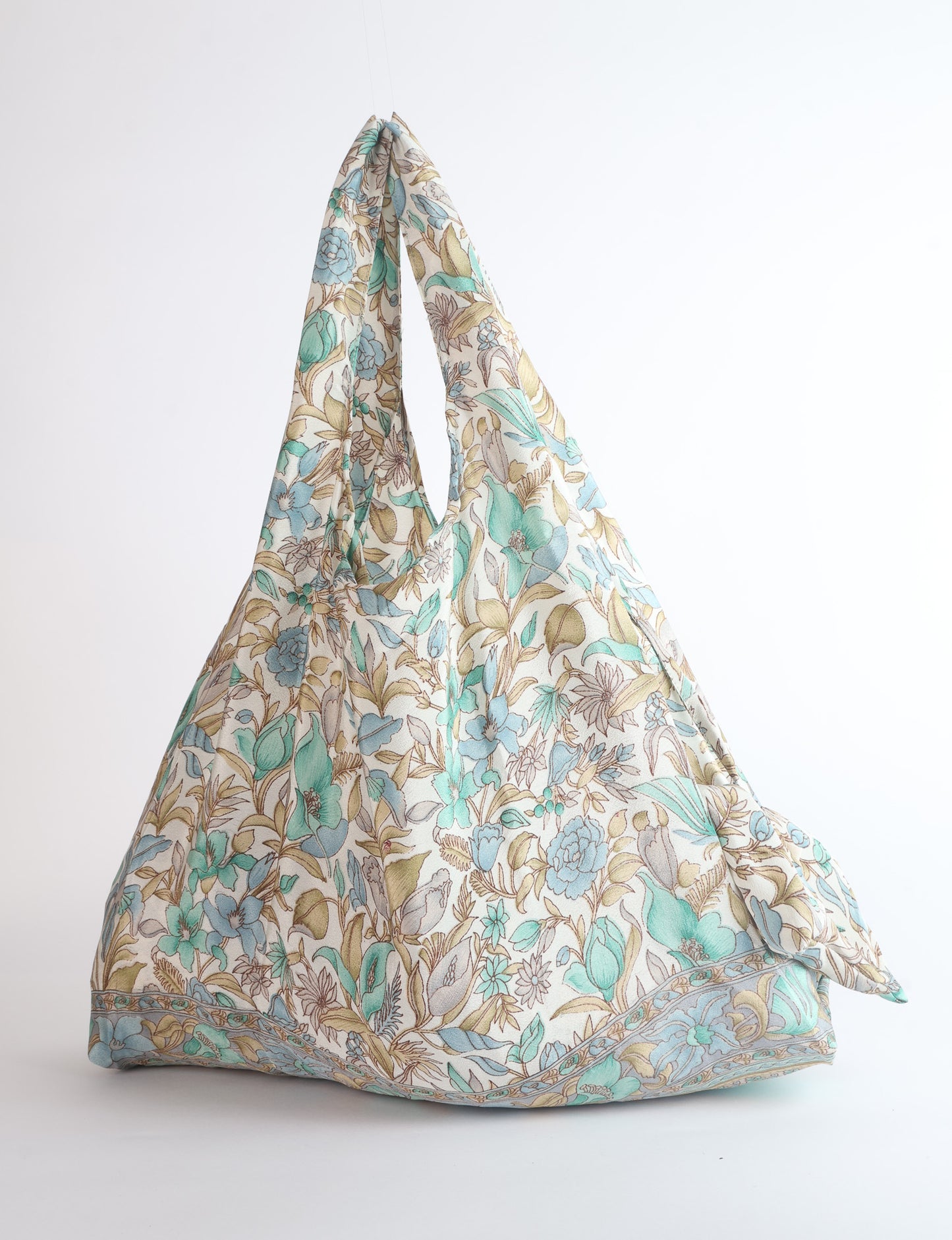 Stay eco-conscious with our Reusable Bag, handmade by Indian artisans from pre-loved saris. Silky and lightweight, this foldaway bag is perfect for your on-the-go lifestyle. Each piece is a unique statement of ethical fashion, embracing sustainability and style.
