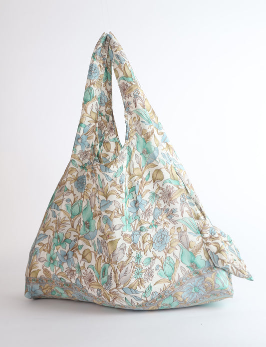 Stay eco-conscious with our Reusable Bag, handmade by Indian artisans from pre-loved saris. Silky and lightweight, this foldaway bag is perfect for your on-the-go lifestyle. Each piece is a unique statement of ethical fashion, embracing sustainability and style.