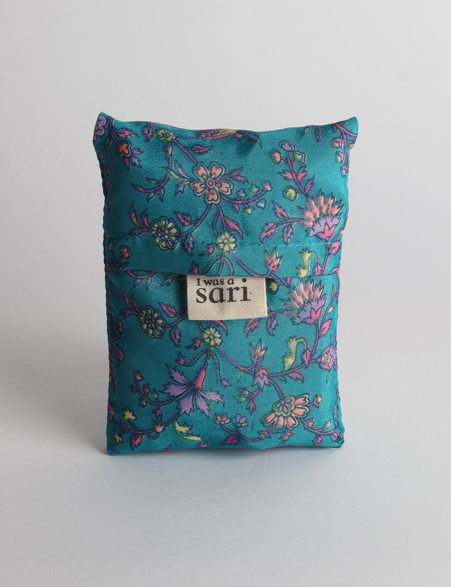 Stay eco-conscious with our Reusable Bag, handmade by Indian artisans from pre-loved saris. Silky and lightweight, this foldaway bag is perfect for your on-the-go lifestyle. Each piece is a unique statement of ethical fashion, embracing sustainability and style.