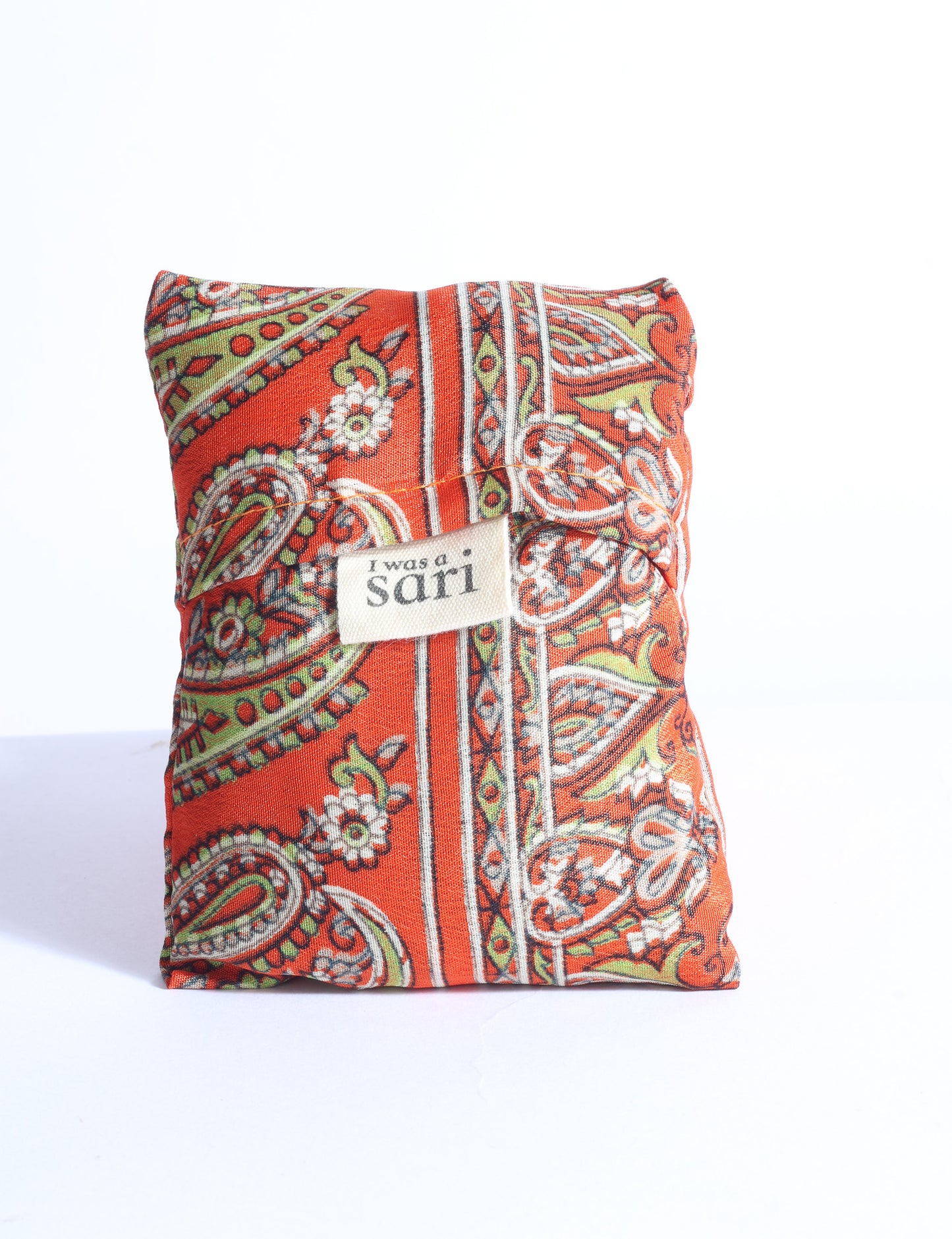 Blue reusable bag with multicolor tropical floral pattern folded with "I was a sari" label visible on front