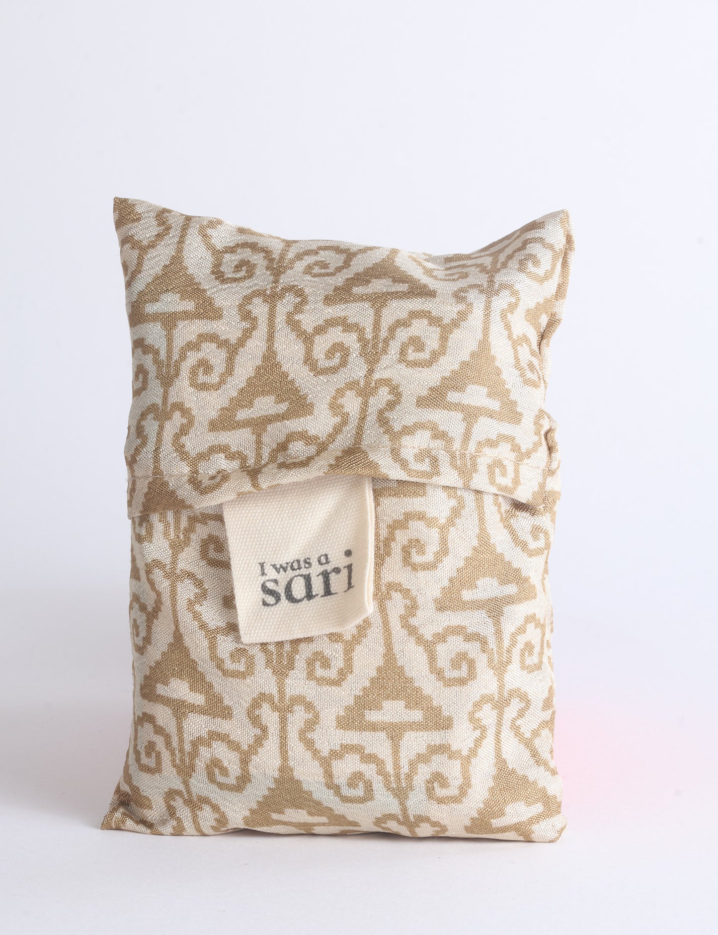 Blue reusable bag with multicolor tropical floral pattern folded with "I was a sari" label visible on front