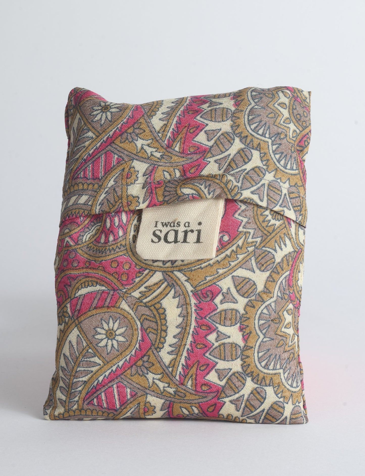 Blue reusable bag with multicolor tropical floral pattern folded with "I was a sari" label visible on front
