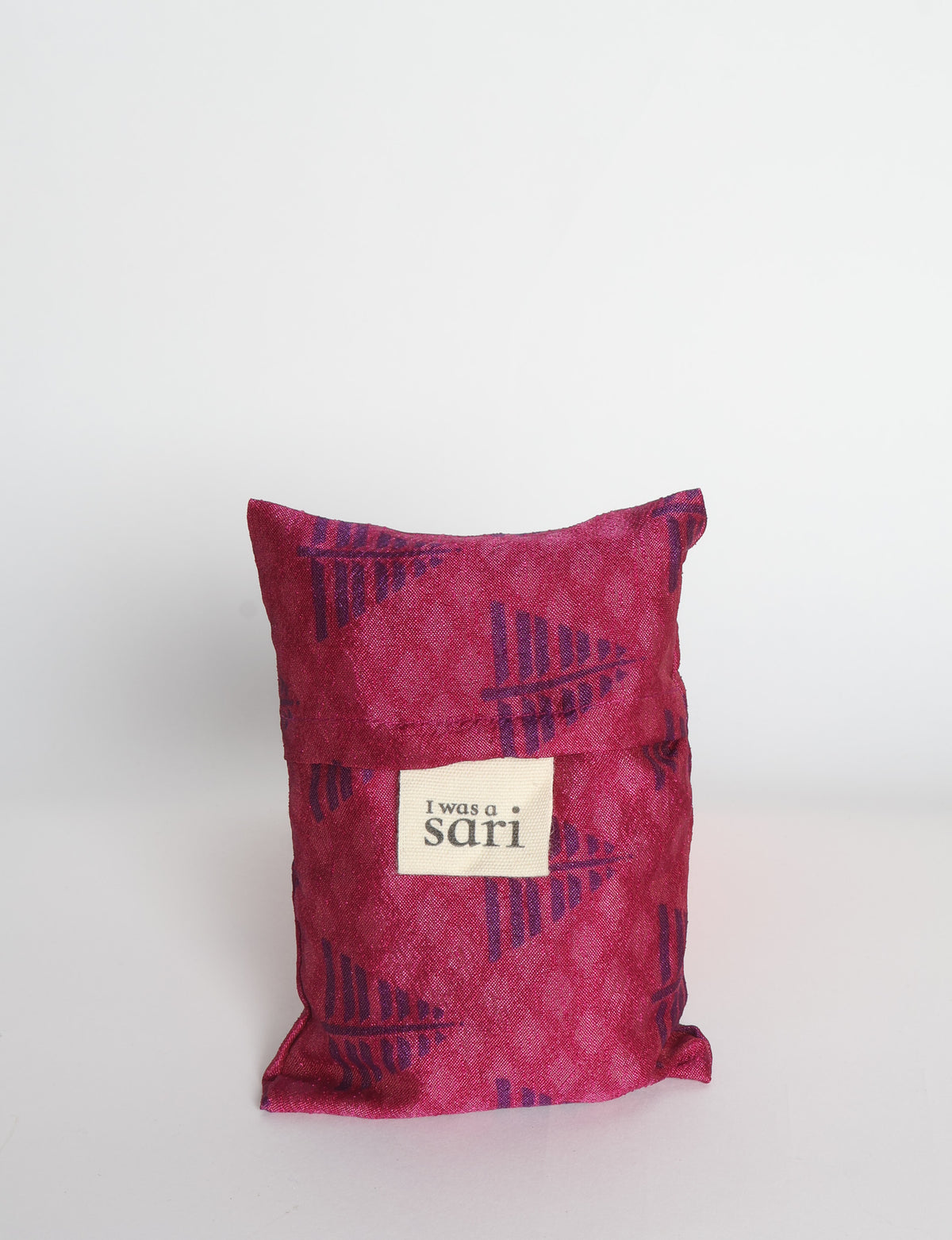 Blue reusable bag with multicolor tropical floral pattern folded with "I was a sari" label visible on front