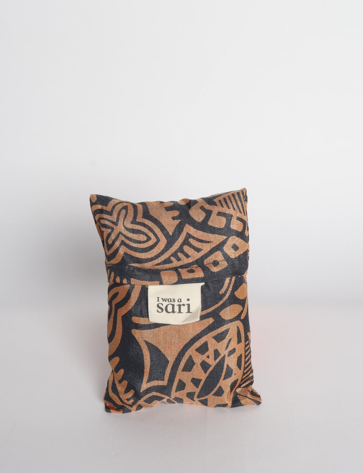 Blue reusable bag with multicolor tropical floral pattern folded with "I was a sari" label visible on front