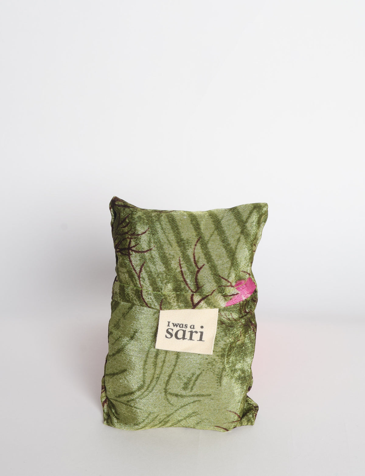Blue reusable bag with multicolor tropical floral pattern folded with "I was a sari" label visible on front