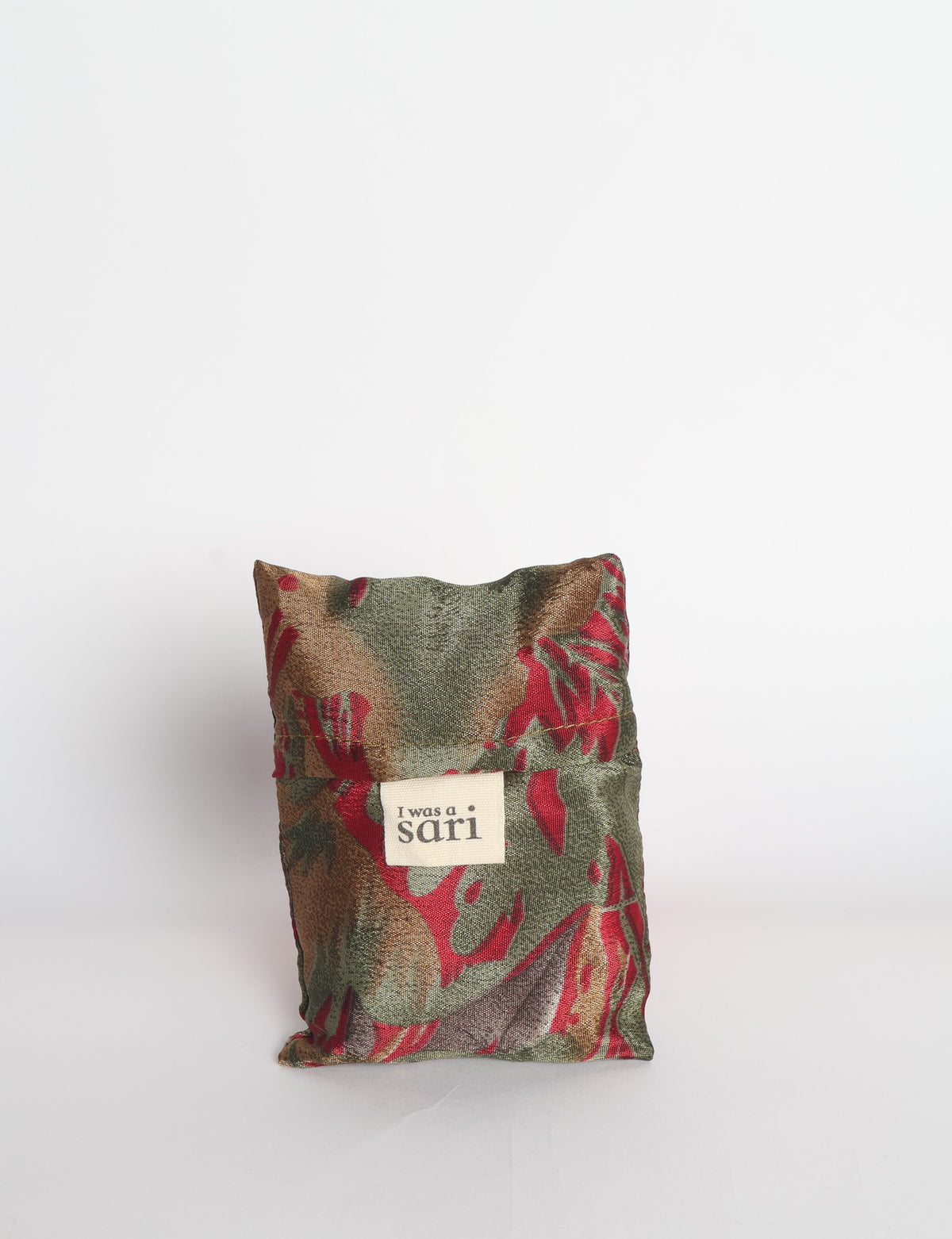 Blue reusable bag with multicolor tropical floral pattern folded with "I was a sari" label visible on front