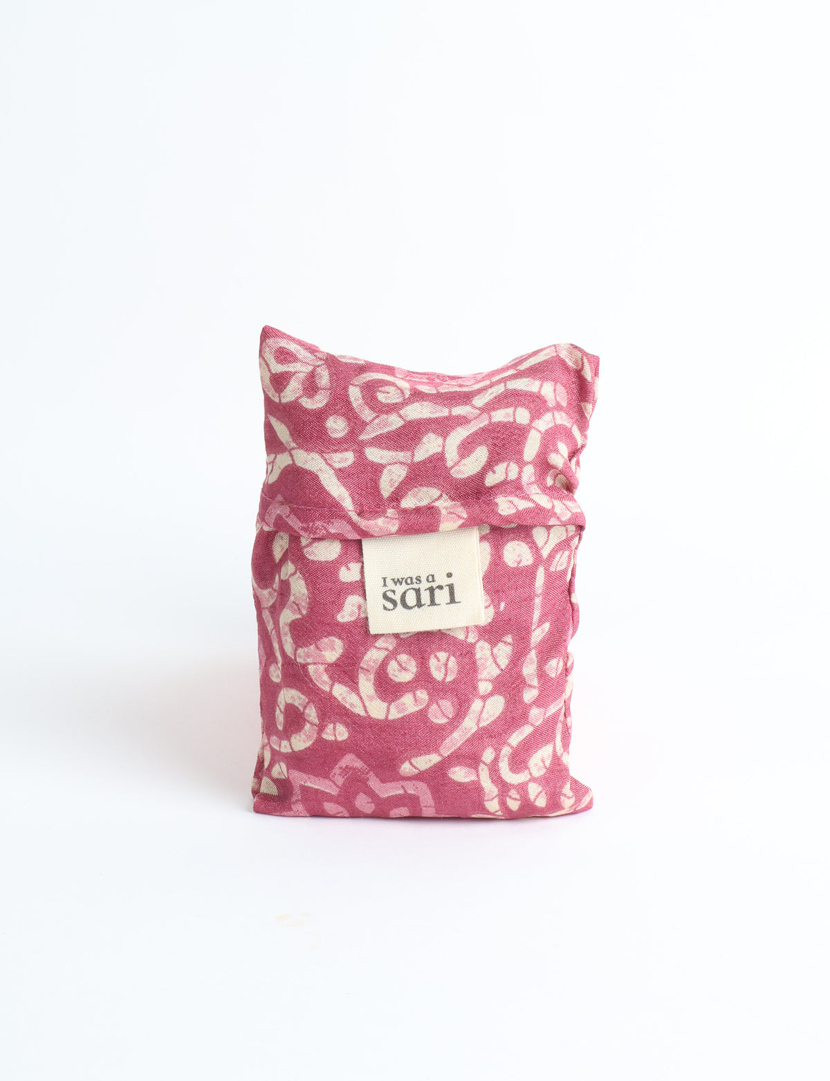 Blue reusable bag with multicolor tropical floral pattern folded with "I was a sari" label visible on front