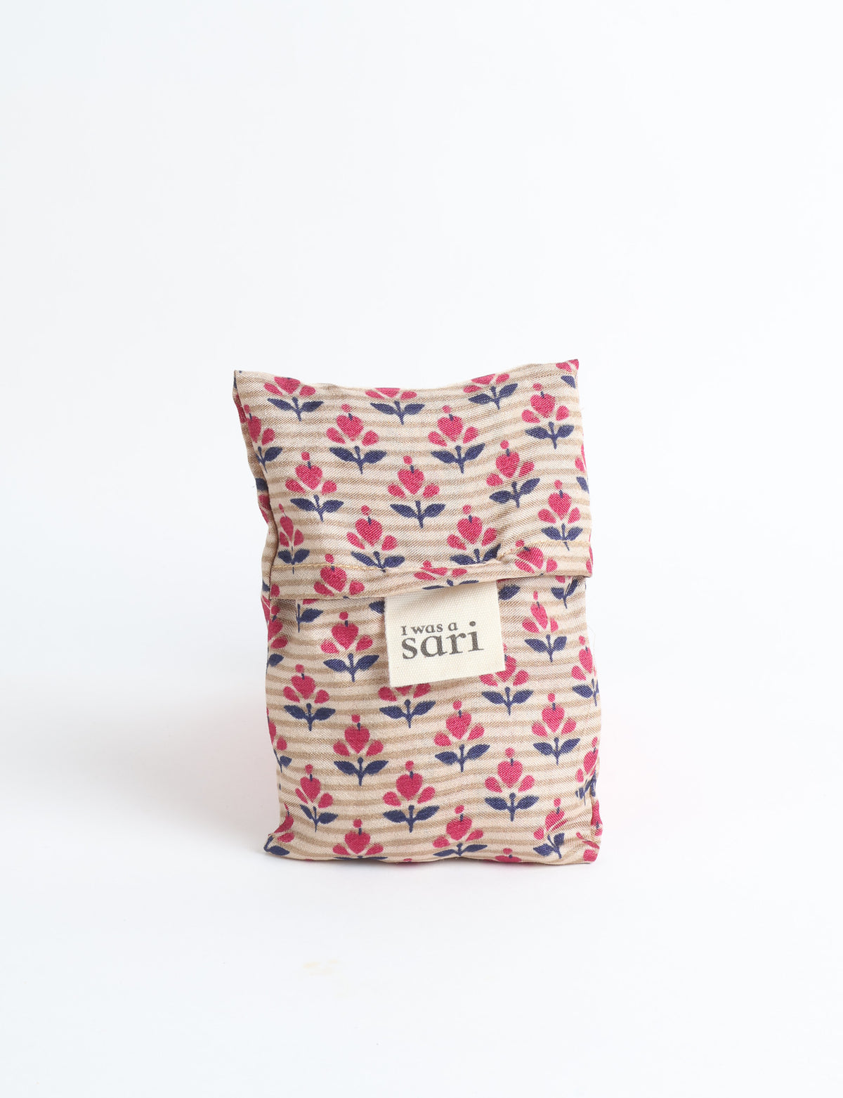 Blue reusable bag with multicolor tropical floral pattern folded with "I was a sari" label visible on front