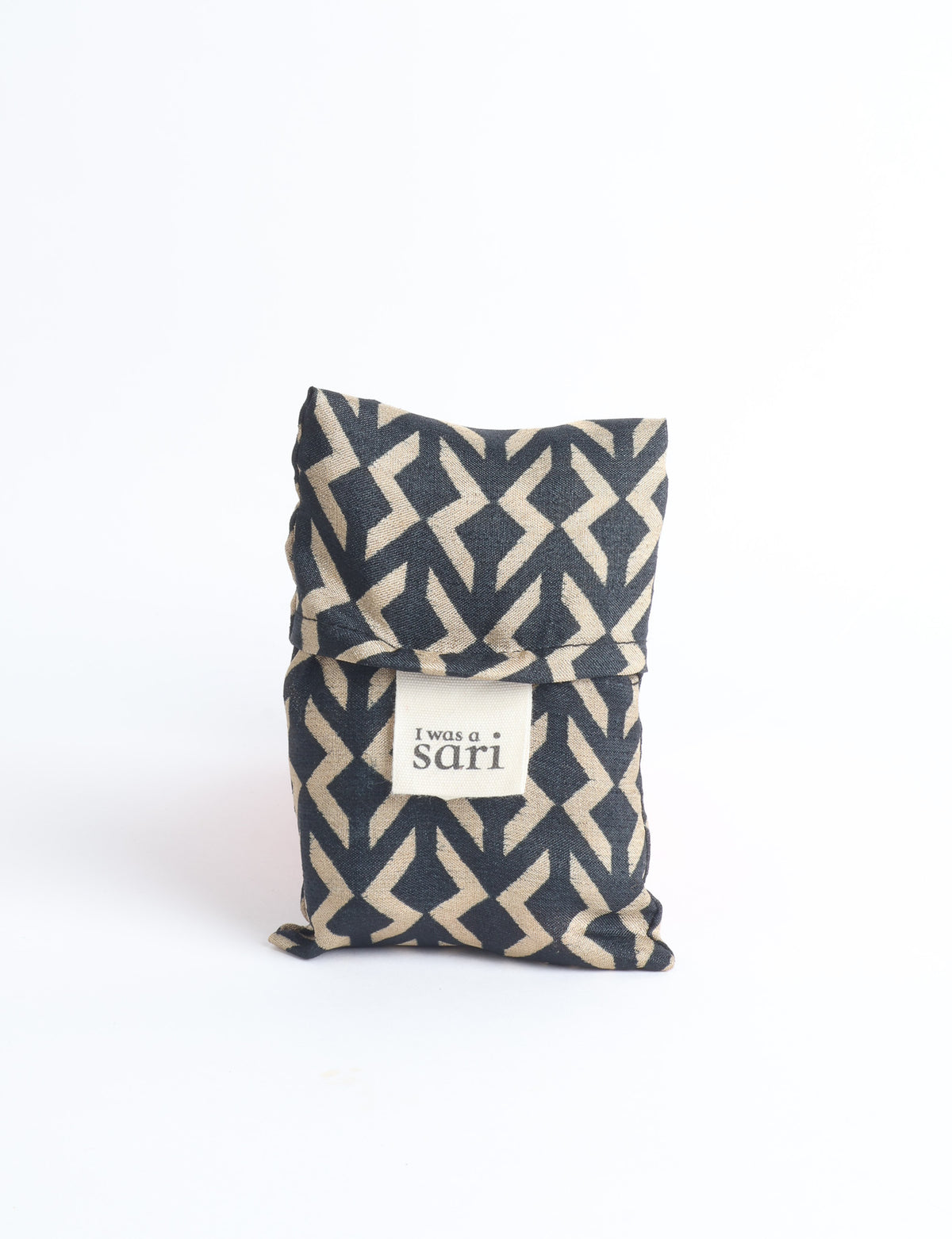Blue reusable bag with multicolor tropical floral pattern folded with "I was a sari" label visible on front