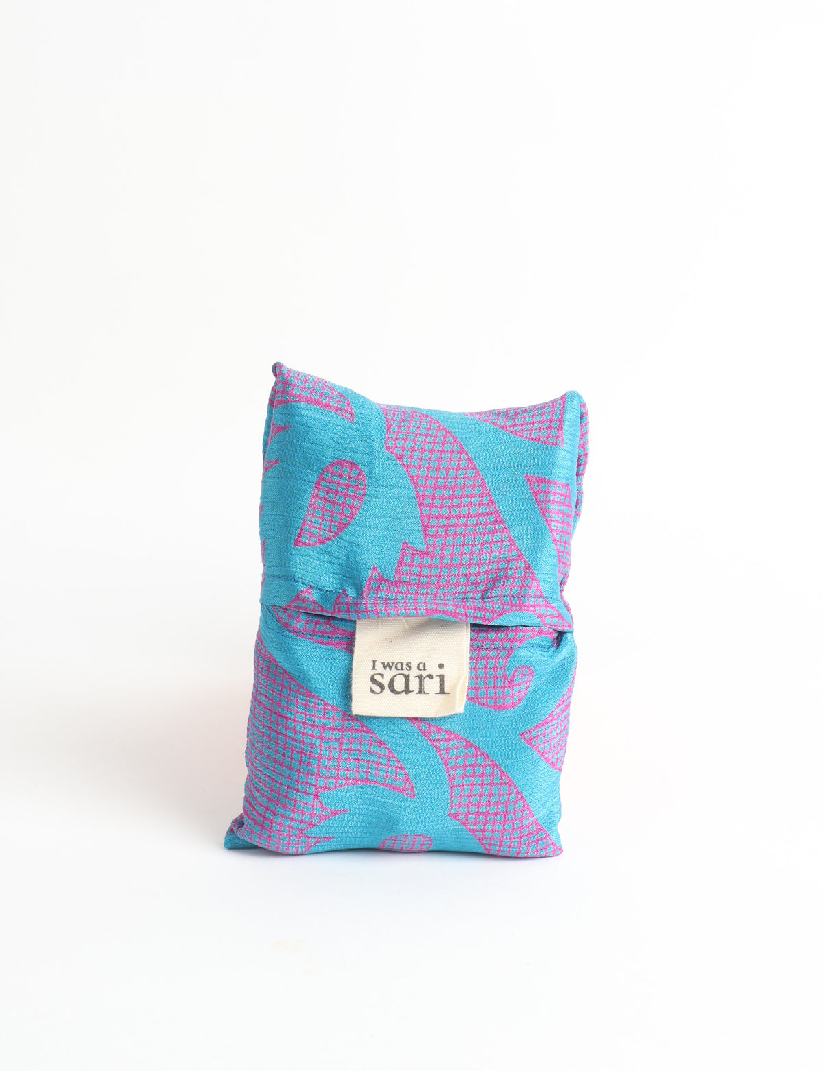 Blue reusable bag with multicolor tropical floral pattern folded with "I was a sari" label visible on front
