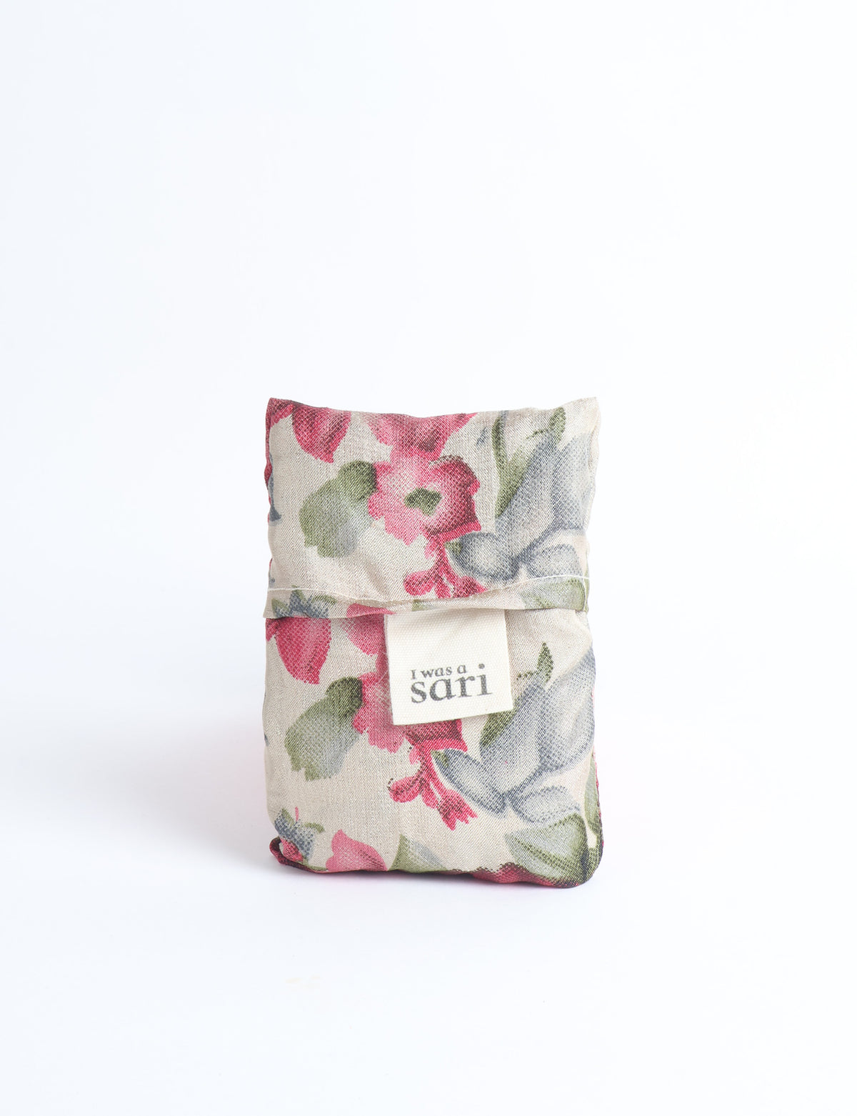 Blue reusable bag with multicolor tropical floral pattern folded with "I was a sari" label visible on front