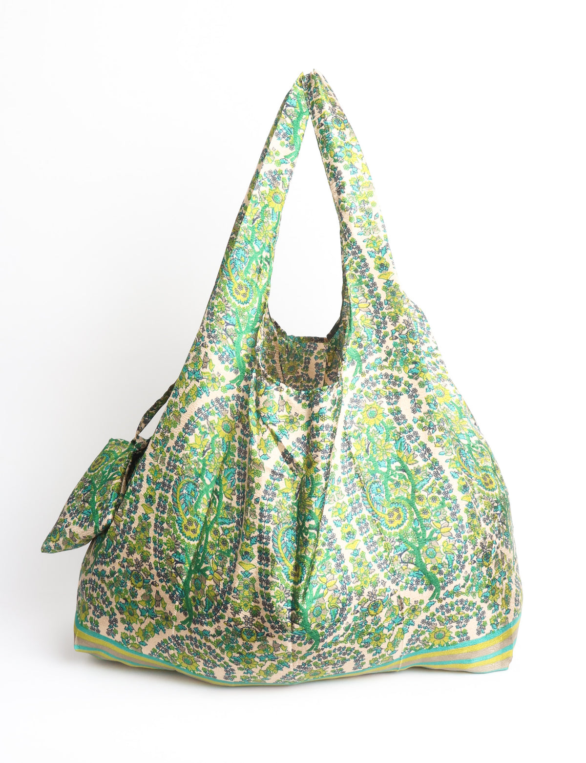 Blue reusable bag with multicolor tropical floral pattern folded with "I was a sari" label visible on front