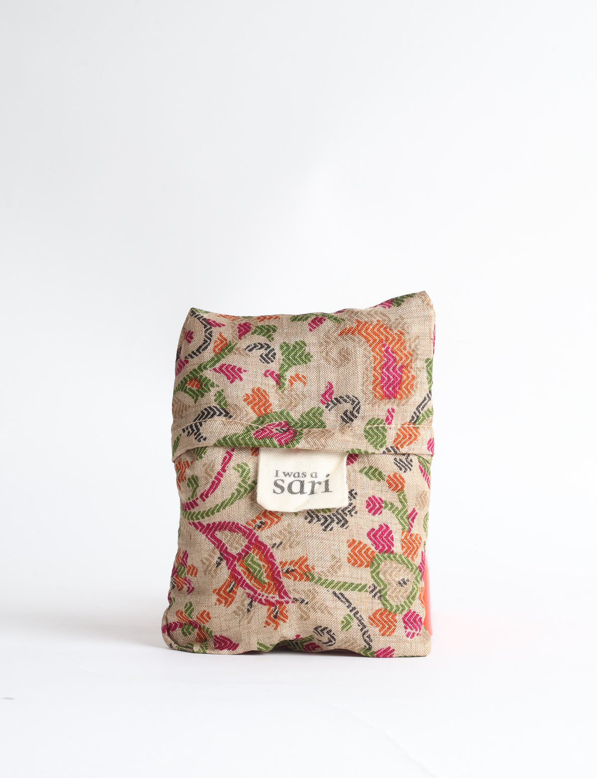 Blue reusable bag with tropical floral pattern in pink, yellow, and green, shown hanging with handles visible