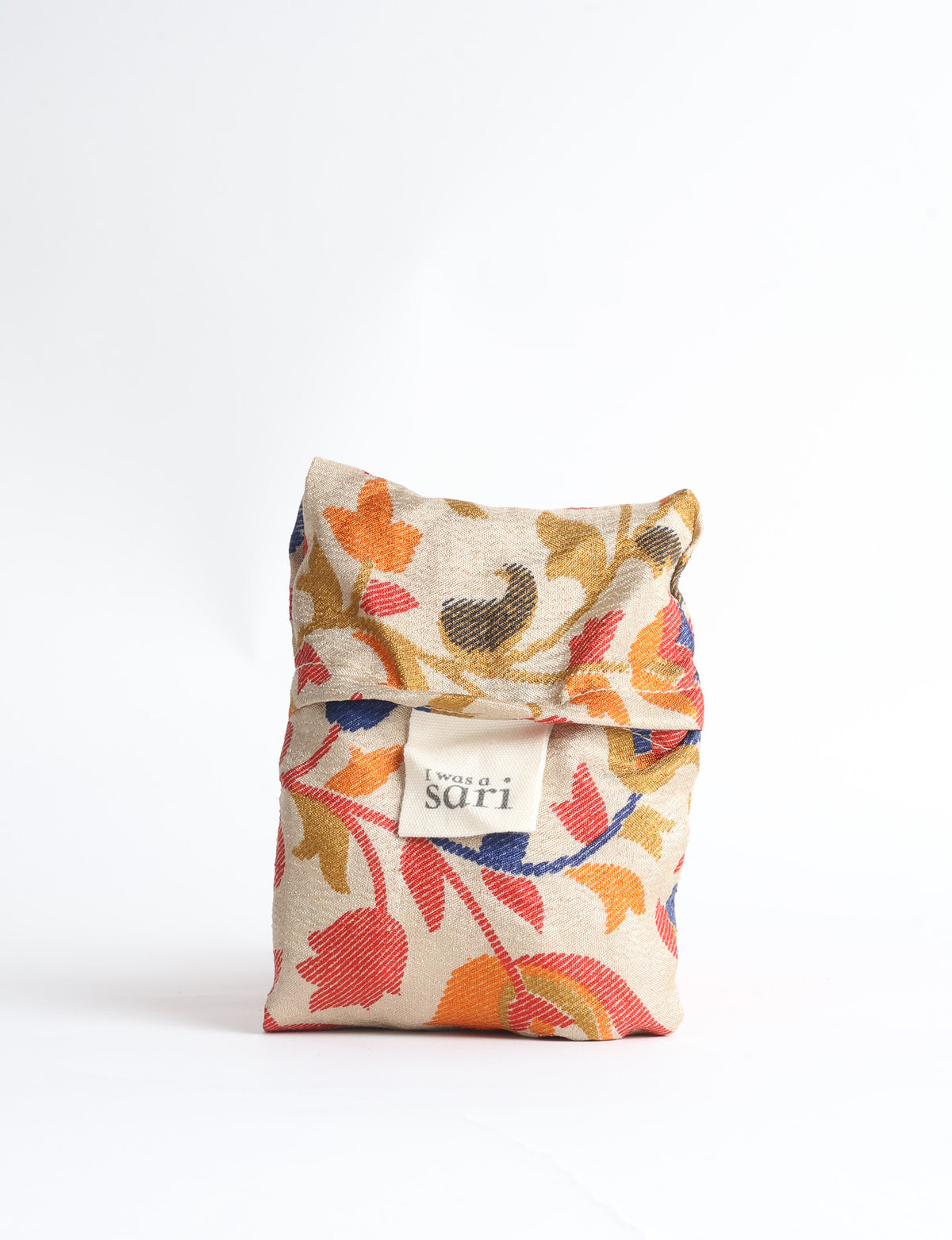 Blue reusable bag with tropical floral pattern in pink, yellow, and green, shown hanging with handles visible