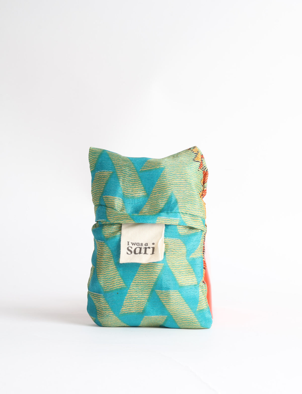 Blue reusable bag with tropical floral pattern in pink, yellow, and green, shown hanging with handles visible