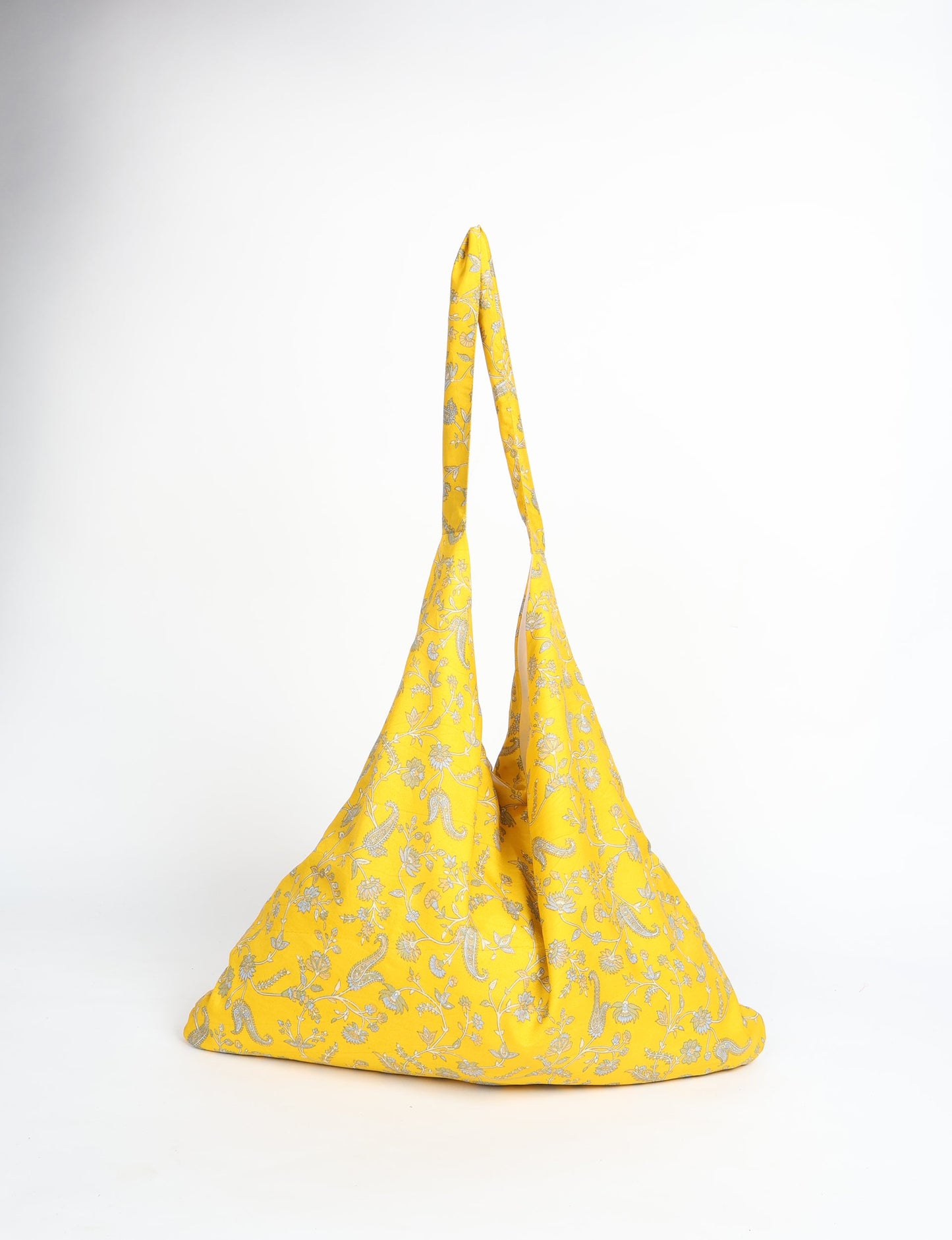 Trapeze bag made from repurposed sari fabric, featuring bold patterns and eco friendly cloth design—part of a sustainable women's clothing collection.