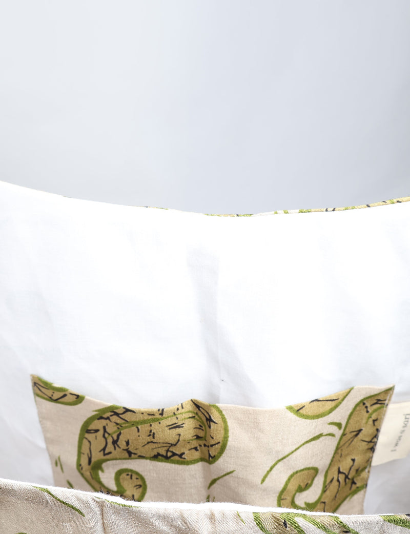 Beige paisley trapeze bag with green and black swirl pattern, shown inside with white fabric lining and interior pocket