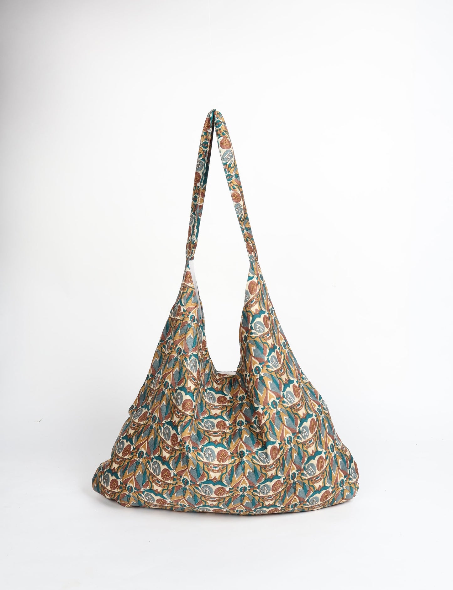 Trapeze bag made from repurposed sari fabric, featuring bold patterns and eco friendly cloth design—part of a sustainable women's clothing collection.