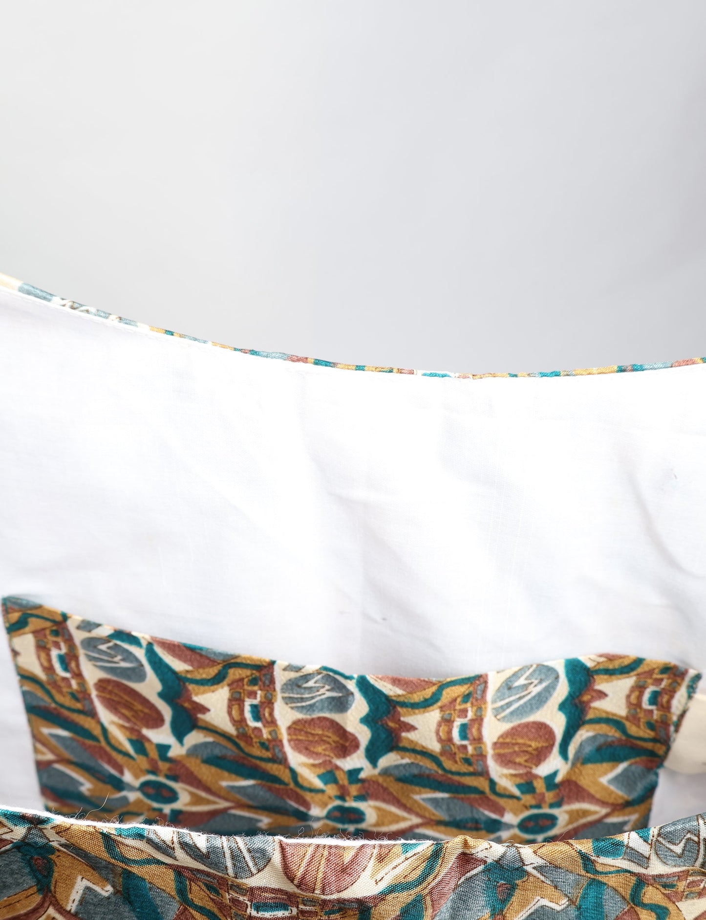 Trapeze bag made from repurposed sari fabric, featuring bold patterns and eco friendly cloth design—part of a sustainable women's clothing collection.