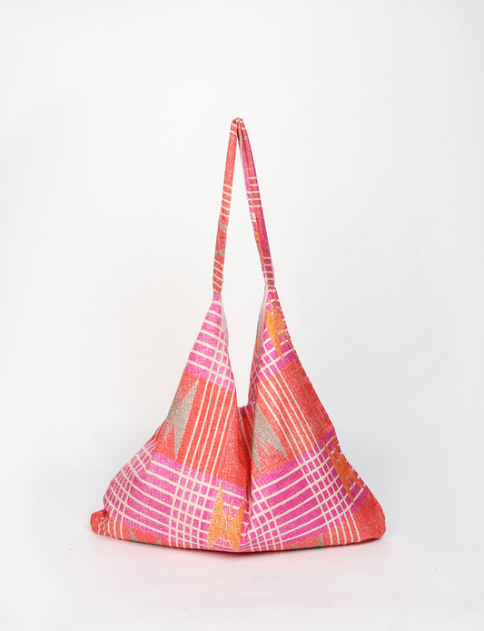 Trapeze bag made from repurposed sari fabric, featuring bold patterns and eco friendly cloth design—part of a sustainable women's clothing collection.