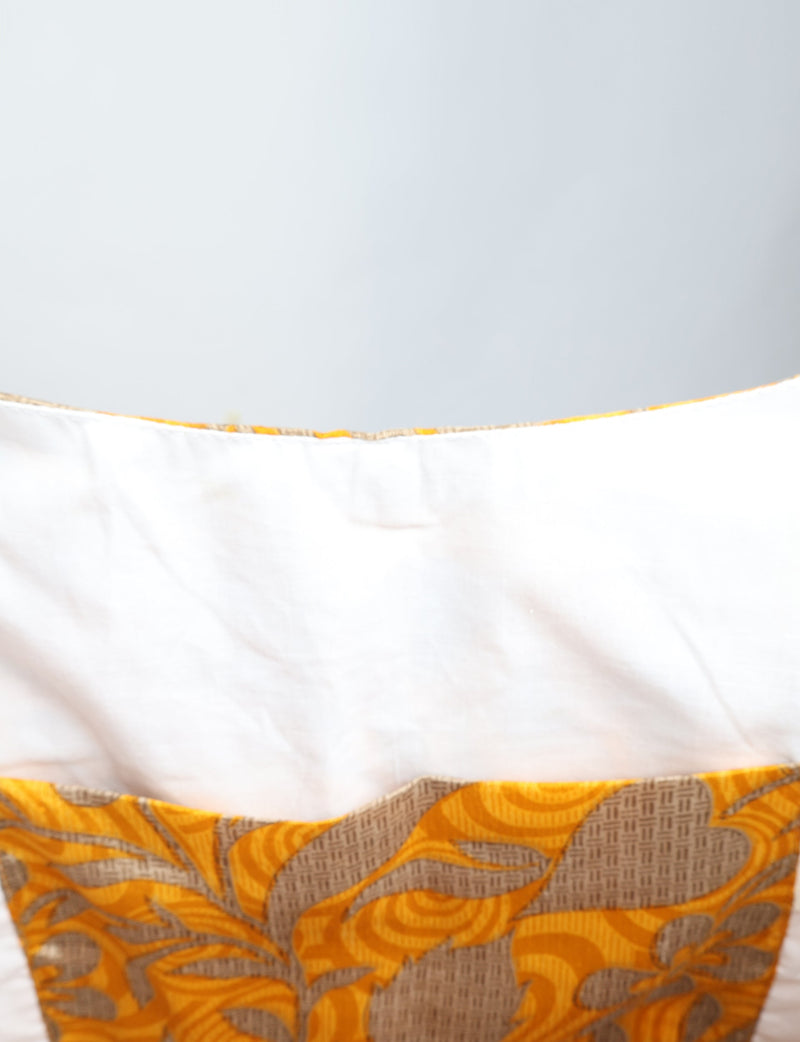 Yellow tropical patterned trapeze bag with white interior lining shown in close-up view