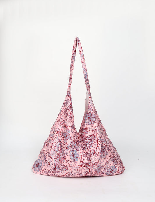 Trapeze bag made from repurposed sari fabric, featuring bold patterns and eco friendly cloth design—part of a sustainable women's clothing collection.