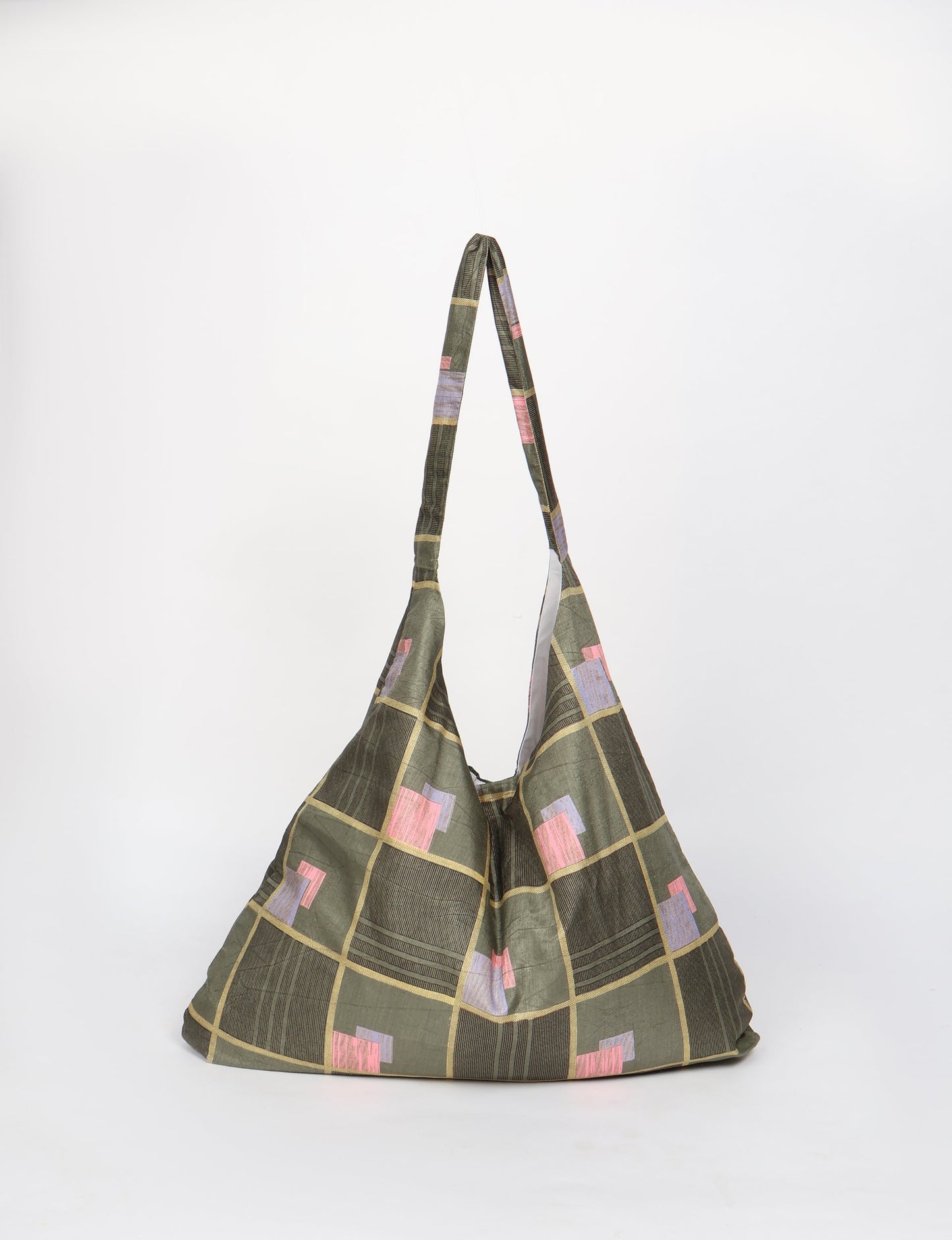 Trapeze bag made from repurposed sari fabric, featuring bold patterns and eco friendly cloth design—part of a sustainable women's clothing collection.