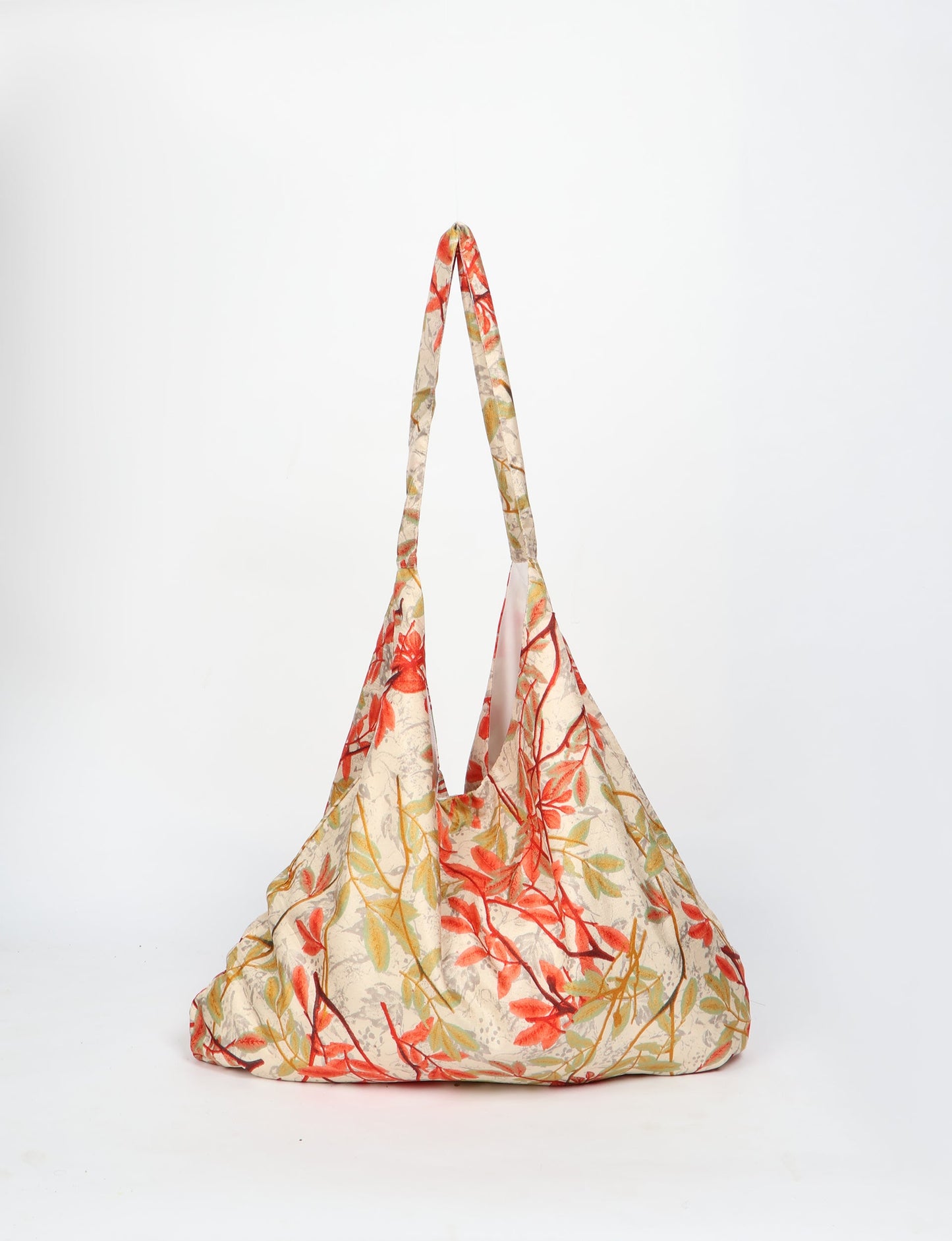 Trapeze bag made from repurposed sari fabric, featuring bold patterns and eco friendly cloth design—part of a sustainable women's clothing collection.