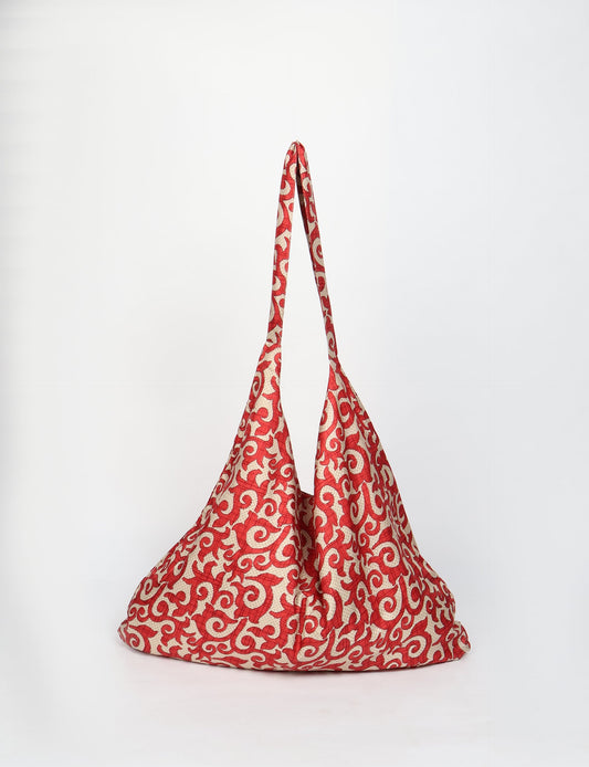 Trapeze bag made from repurposed sari fabric, featuring bold patterns and eco friendly cloth design—part of a sustainable women's clothing collection.