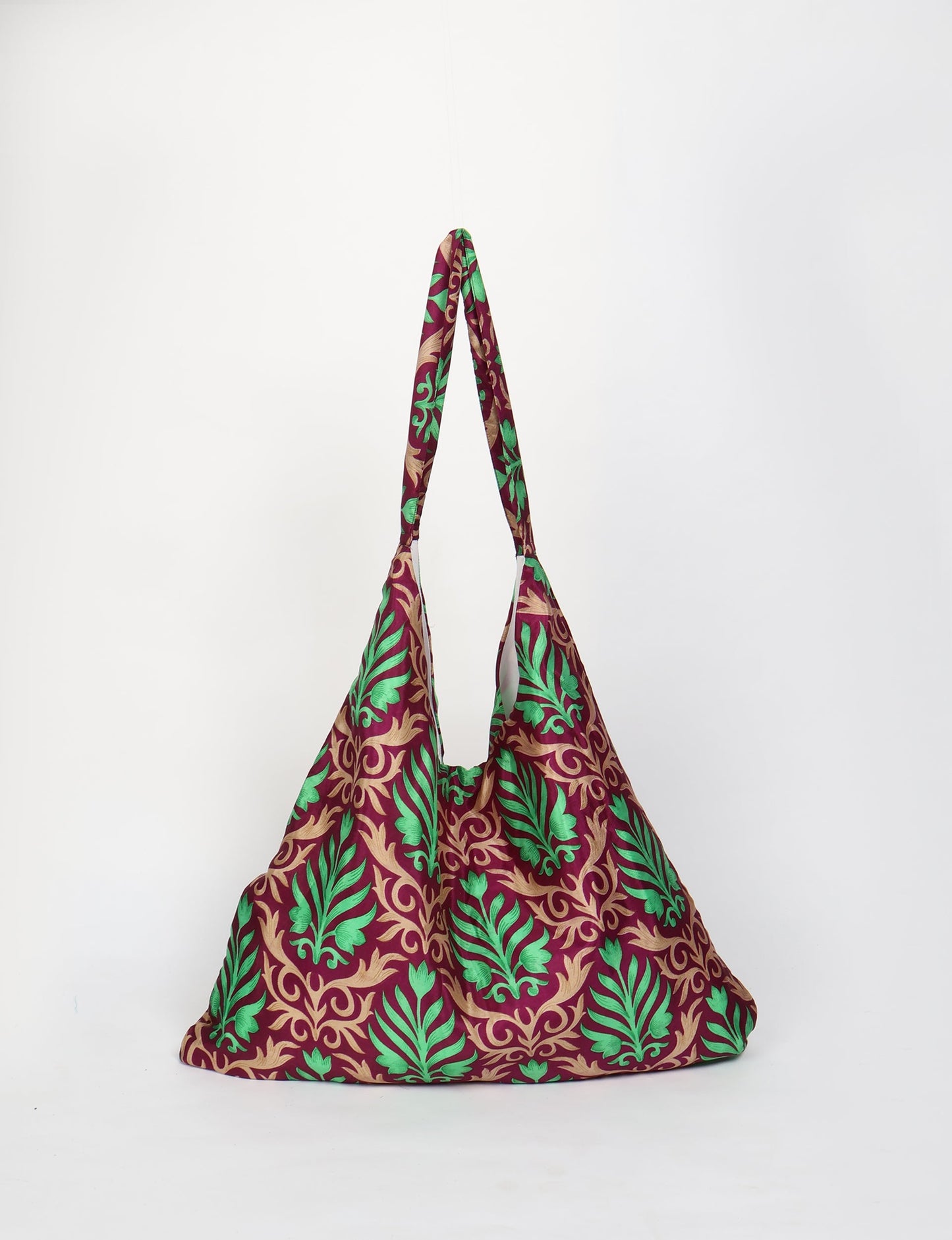 Trapeze bag made from repurposed sari fabric, featuring bold patterns and eco friendly cloth design—part of a sustainable women's clothing collection.