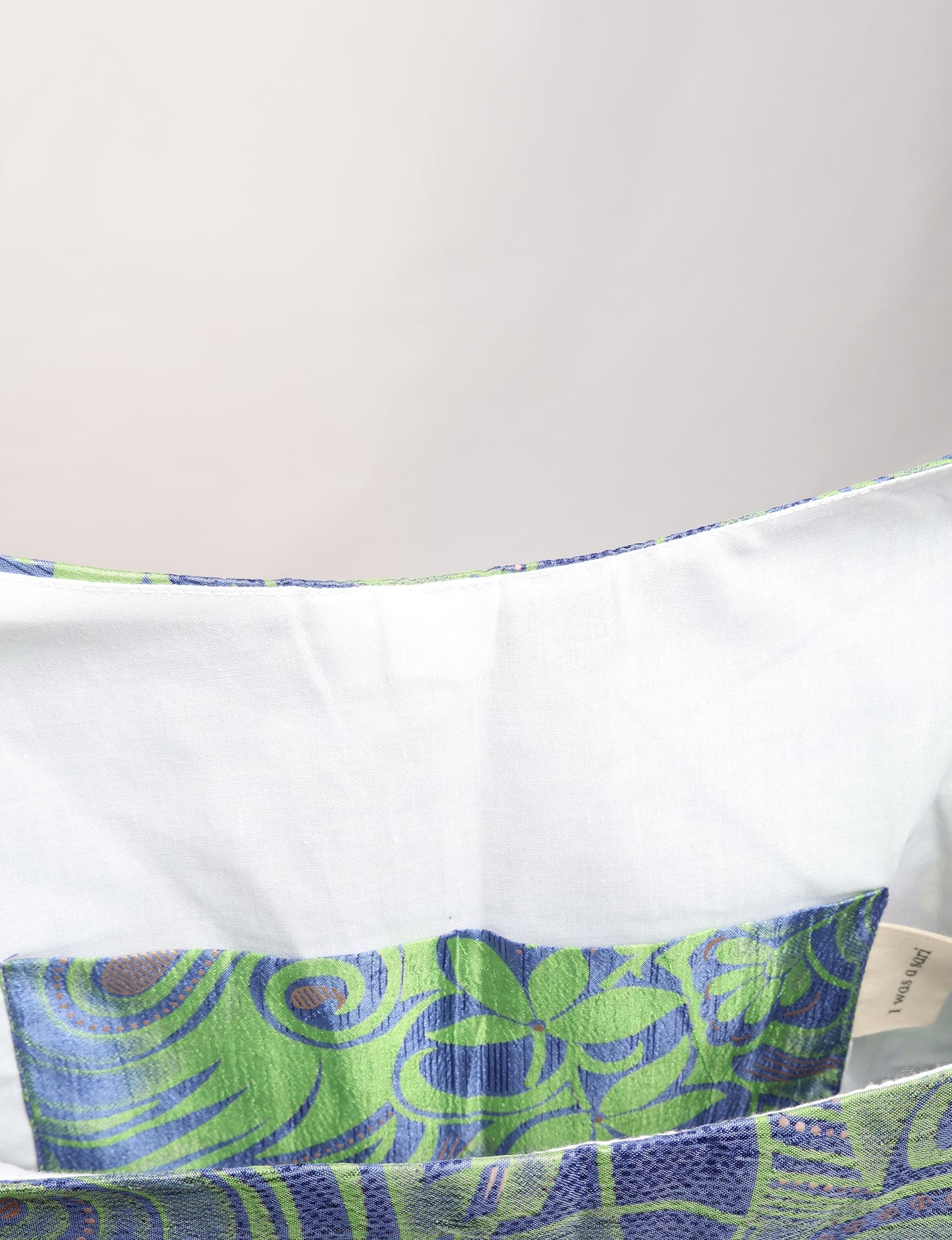 Trapeze bag made from repurposed sari fabric, featuring bold patterns and eco friendly cloth design—part of a sustainable women's clothing collection.