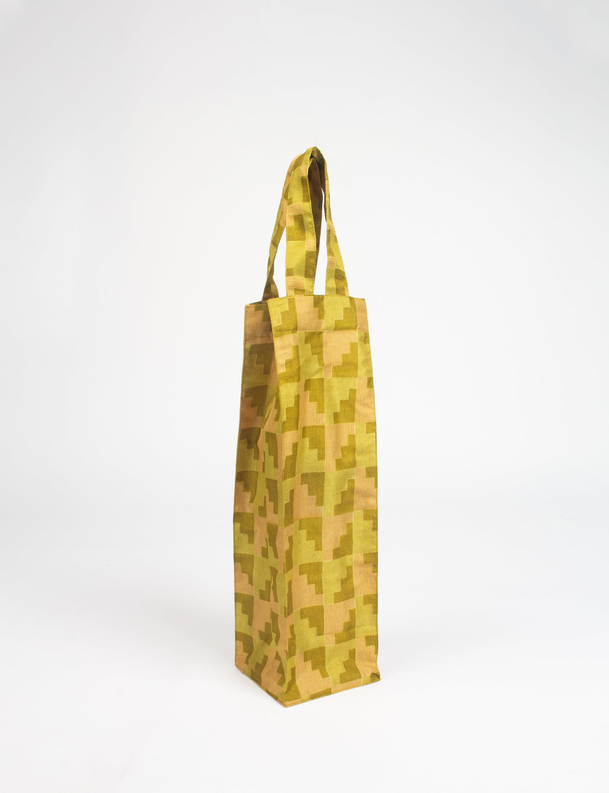Green and yellow geometric patterned fabric wine bag with two handles, shown standing upright on a white background