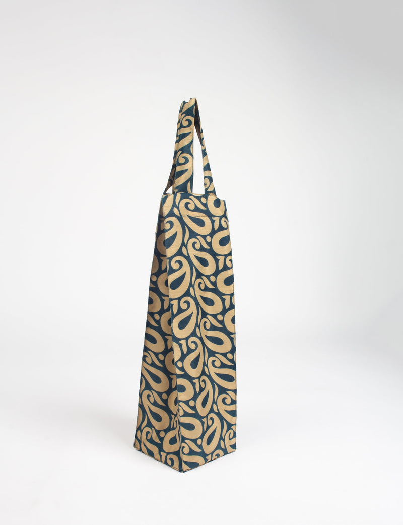 Blue and beige paisley patterned fabric wine bag with a single handle, standing upright on a white background