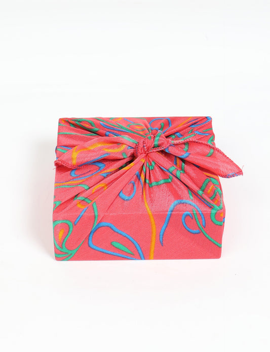 A delicately handcrafted wrap made from recycled sari offcuts, blending sustainable fashion with conscious design. This eco-friendly product showcases the beauty of upcycling and green fashion, making it a perfect accessory for those supporting circular fashion and products made from textile waste.