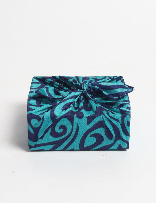 A delicately handcrafted wrap made from recycled sari offcuts, blending sustainable fashion with conscious design. This eco-friendly product showcases the beauty of upcycling and green fashion, making it a perfect accessory for those supporting circular fashion and products made from textile waste.